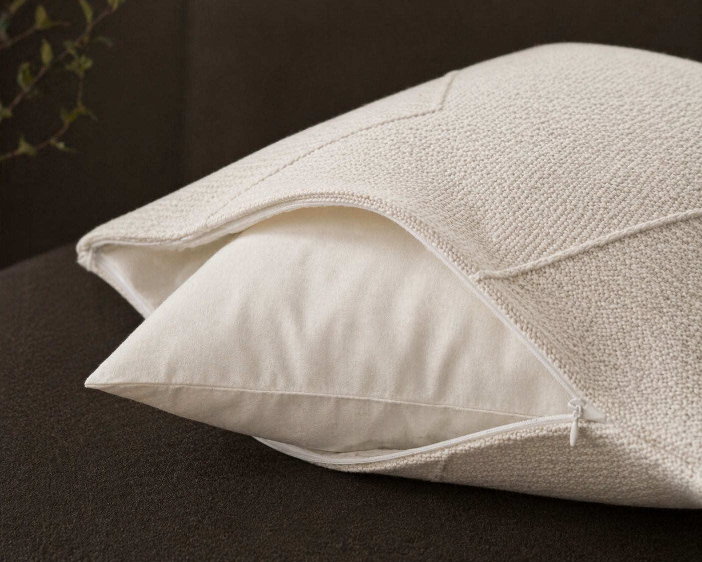 Held by Miru cushion cover unzipped, showing the inner pillow that houses the connected glow.