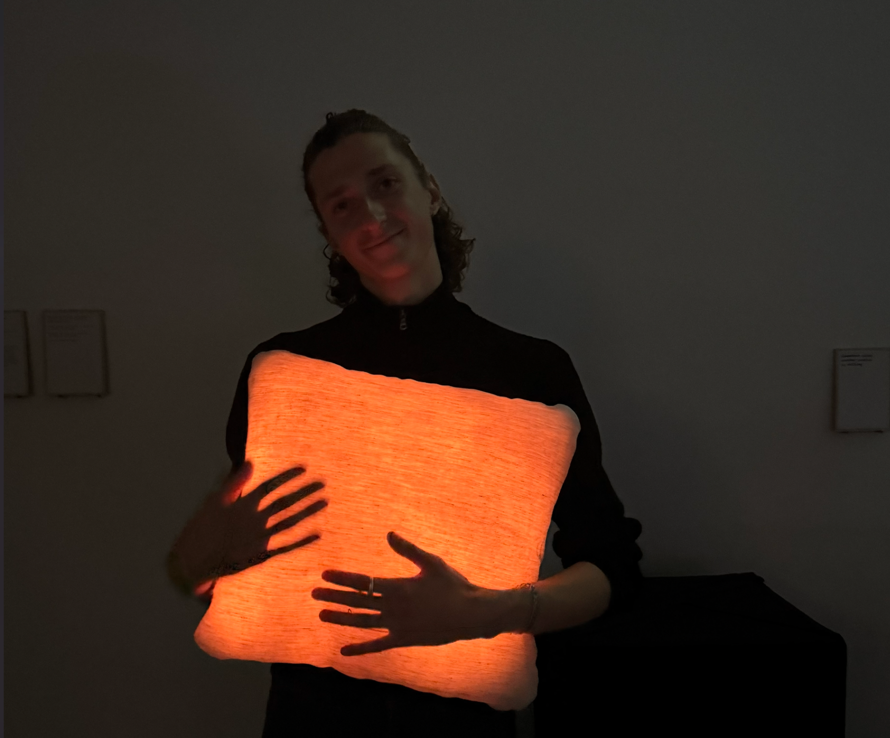 Person holding a glowing Miru cushion close